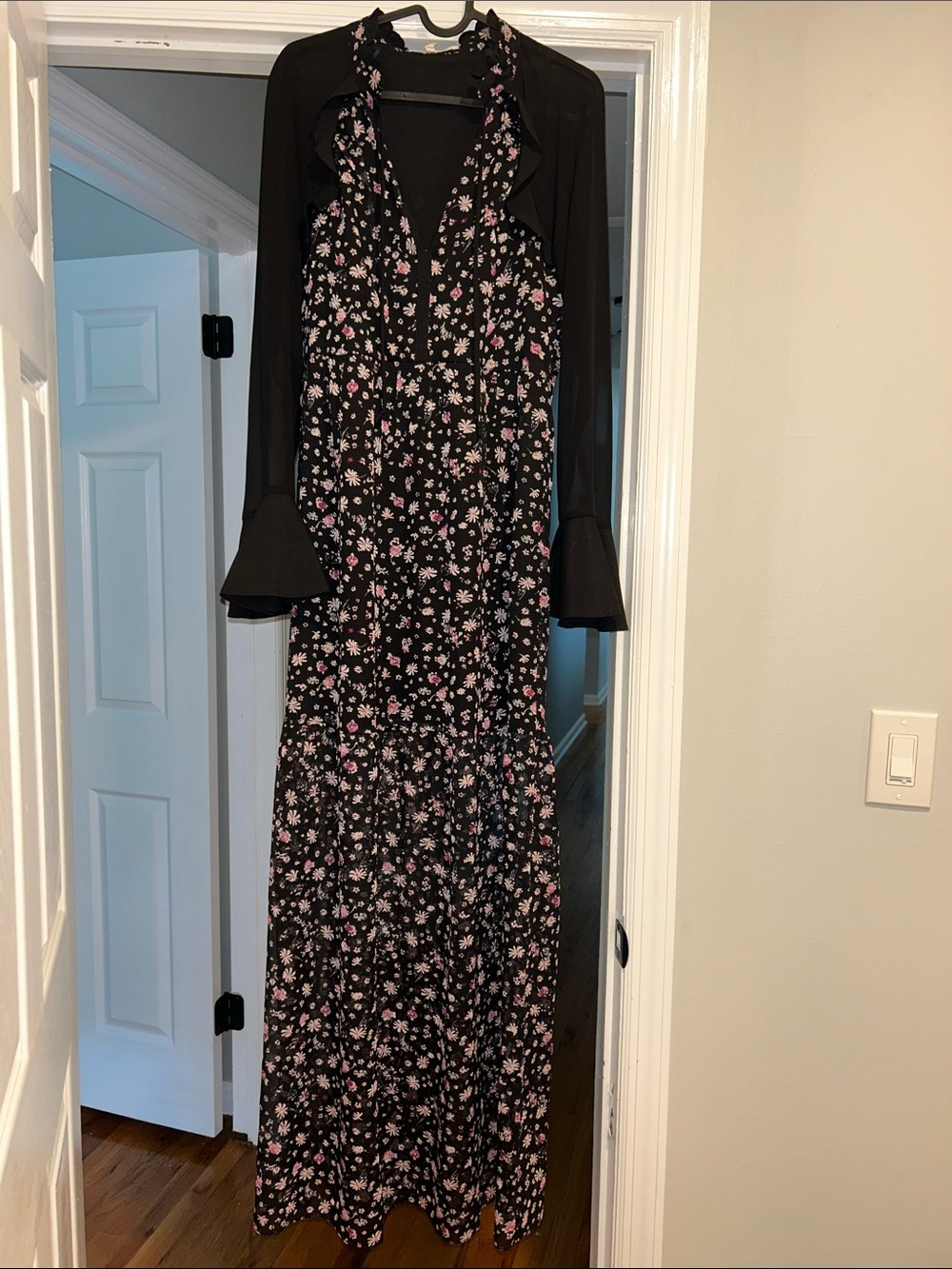 BCBGeneration floral maxi dress with sheer black long-sleeve overlay.